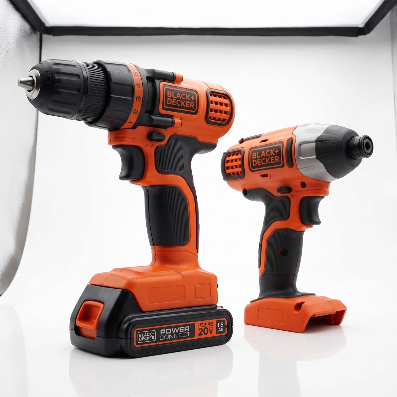 The drill/driver and the impact driver standing side by side on a plain white background, in the orange and black BLACK+DECKER colourway, with the drill's numbered clutch collar facing the camera.