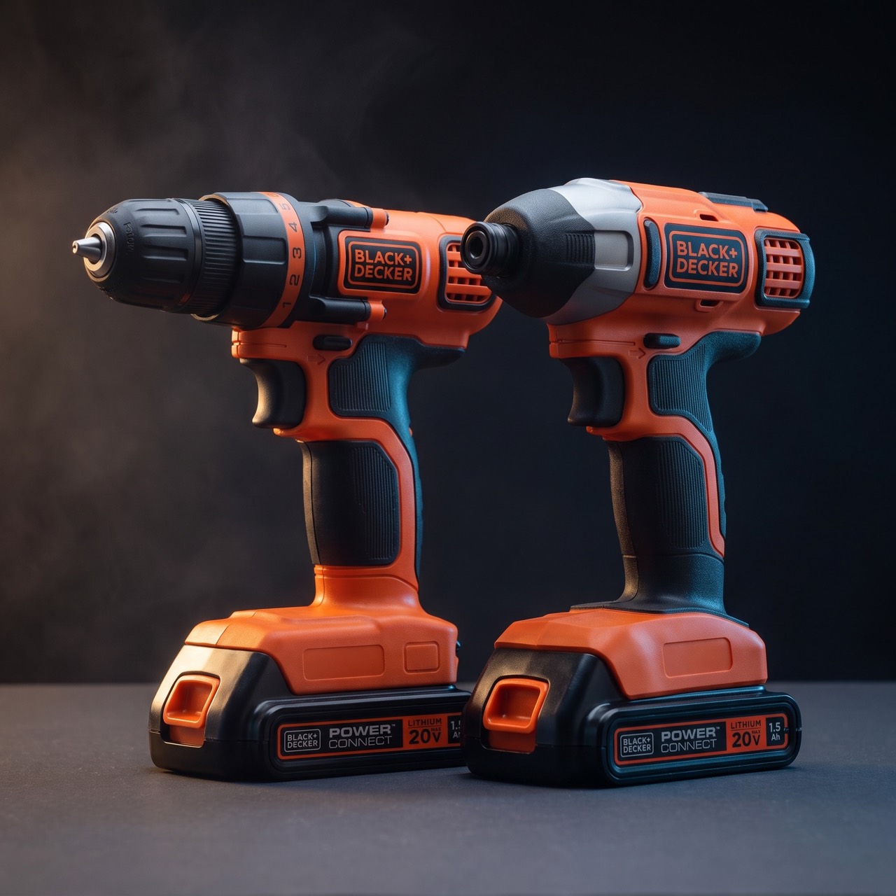 The same two tools on a dark charcoal surface under hard side lighting, which picks out the keyless chuck on the drill and the hex collar on the impact driver.